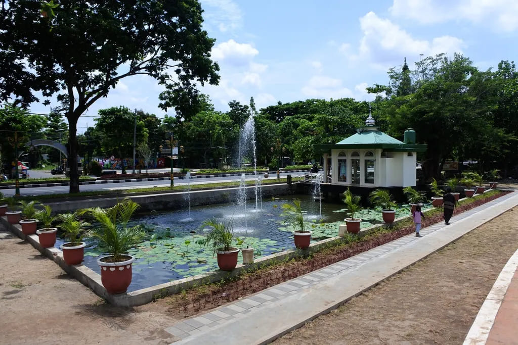 Children planting trees during a community event at Mataram City Park.